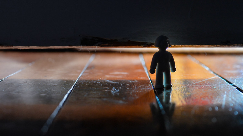 Image of Lego figure standing alone on bare floor